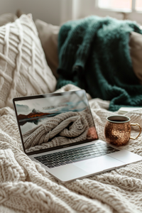 Vertical_closeup_of_MacBook_Pro_open_on_cream_knit_blanket_sc_4c62d812-001c-459f-a920-5b76ca7ee362_0
