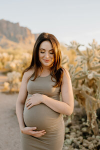 pregnant woman holds belly