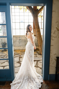 seattle bride poses in bridal suite at The Ruins
