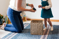 Mother showing their small child how a toy works