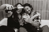 Couple partying in a bathtub with champagne and a disco ball in Breckenridge, Colorado.