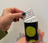hand-placing-note-in-jar