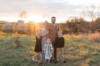 family posed outdoors at heritage hills park