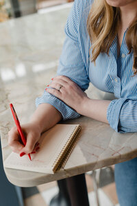 Close up of Anna Bradshaw copywriter writing in a notebook 