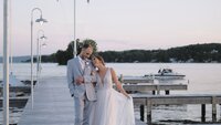 bride and groom walking Canandaigua Lake at sunset