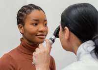 Close-up of a doctor examining a patient’s eye with a slit lamp, illustrating glaucoma screening and comprehensive eye health evaluation