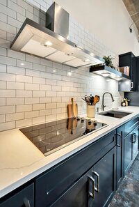 Kitchen with subway tile  in this 3-bedroom, 2-bathroom luxury condo in downtown Waco, TX
