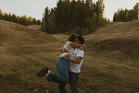 A black and white shot of a soon to be bride and groom running across a bridge.