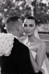 Bride looks into the camera for classic black and white photo