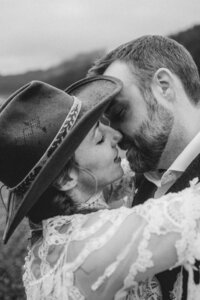black and white close up of bride and groom kissing