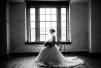 bride sitting in a chair in from of a window
