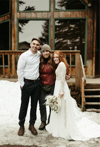 woman standing with bride and groom after their alaska elopement