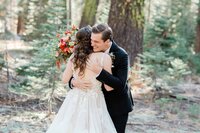 A groom hugs his bride after seeing her for the first time on their elopement day in Yosemite National Park. 