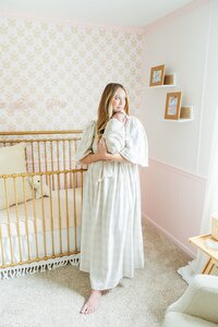 newborn baby girl swaddled in mom's arms in a nursery near Greenville and Kinston, NC