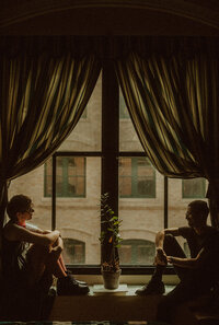 man and woman sit by a window in Boston