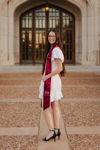 girl posing for graduate photos in dallas texas