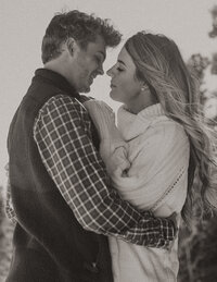 Engaged couple taking engagement photo in downtown Minneapolis