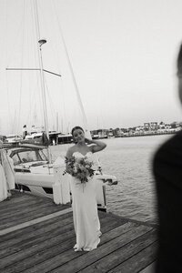 couple exchanges vows in martha's vineyard under a large tree surrounded by friends and family