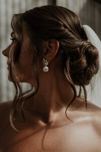 bridal portrait in field holding bouquet
