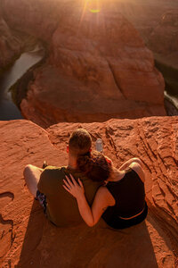 A bride and groom eloping at Horseshoe Bend, surrounded by the natural beauty of the canyon and the Colorado River below.