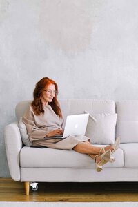 women on a sofa on a macbook
