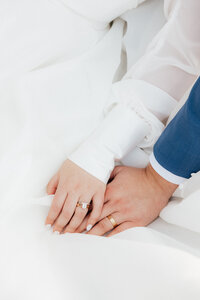 Flat lay of of rings and wedding invitations.