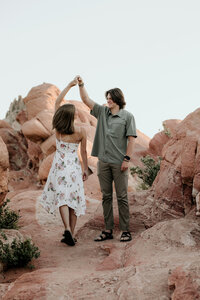 couple dancing on red rocks