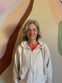Courtney smiling in the yoga studio