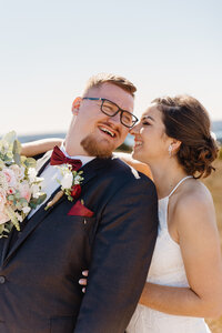 A person looking over their shoulder to their partner as they both smile