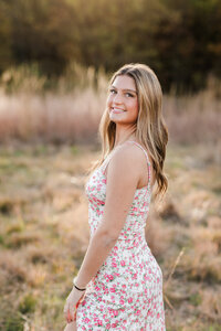high school senior girl in floral dress at westcreek reservation for senior portraits