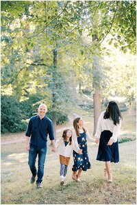 family walking together in a field Atlanta Family Photographer