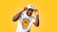 a guy wearing a smiley face t-shirt and hat