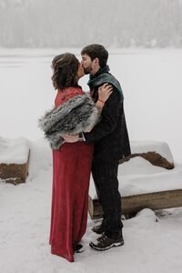 Bride and groom share first kiss following wedding ceremony.