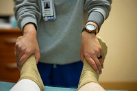A nurse's hands on a patient's feet