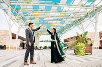 An Indian engagement couple dance together in downtown Cincinnati, Ohio, for their engagement photos.