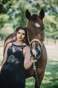 woman standing next to horse