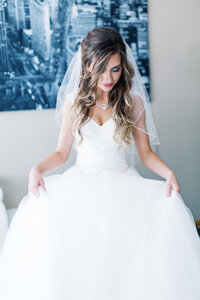 Fine wedding details in the brides dress as she shows off her beautiful gown, captured by Minnesota Fine Art wedding photographer.