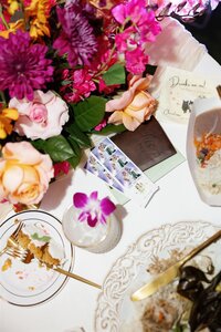 A half-eaten piece of cake on a table with a colorful floral arrangement 