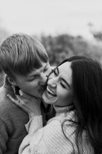 Morgan, a wedding and elopement photographer and photography educator, smiling while working on a laptop, offering valuable tools, resources, and coaching for photographers on the Education for Photographers page.