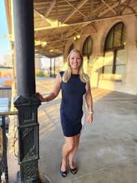 Doctor and podcaster Stephanie Zwonitzer standing in a black dress