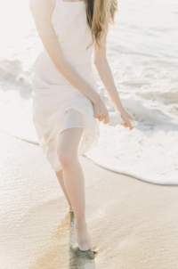 Natural light brand portrait of woman on sandy beach