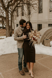 bride and groom snuggling during photos after courthouse elopement in Appleton, Wisconsin