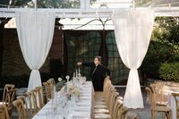 A top wedding planner in Chicago lighting candles on the dinner tables 