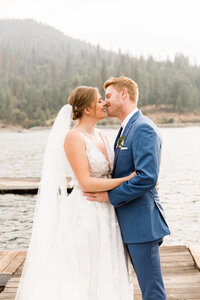couple kissing on dock at bass lake