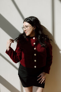 Shanté Gorman, founder of Sugarpunch Marketing®, a social media and content agency, wearing a red jacket and looking to the side.
