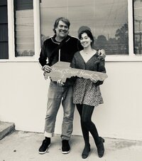 Happy homebuyers standing together and holding a ‘Home Sweet Home’ sign, featured as a client testimonial for San Diego realtor Mary Pernicano — Mary Pernicano Real Estate.