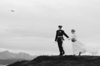 Bride kissing her husband on the beach at sunset