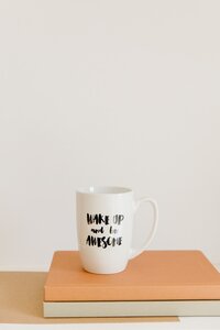 A white mug with the words 'Wake up and be awesome'