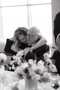 Bride hugs dad at wedding