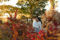 Engaged couple taking engagement photos at The Armory concert venue in downtown Minneapolis